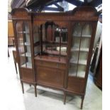A good quality Edwardian Arts & Crafts style display cabinet with inlaid floral marquetry detail,