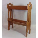 An Arts & Crafts style oak/possibly elm two tier book stand with pierced heart and further detail,