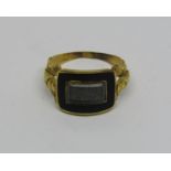Early Victorian enamelled mourning ring set with woven hair, worn inscription to interior, gold