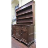 A late 18th century Welsh breakfront dresser, the front elevation enclosed by a T shaped arrangement