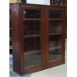 A 19th century mahogany bookcase enclosed by a pair of rectangular glazed panelled doors, 98 cm wide