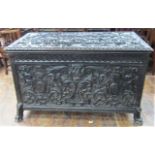 A substantial 19th century continental coffer with extensive carving and scrolled griffin