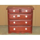 A stained pine apprentice piece in the form of a Victorian bedroom chest fitted with two short