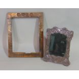 An Arts & Crafts copper clad picture frame with foliate and hammered detail, (lacks backing/