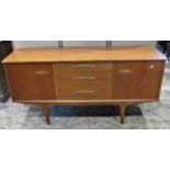 A mid 20th century teak sideboard fitted with a tower of three central drawers flanked by
