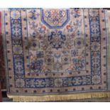 A heavy wool carpet in the Persian style, the beige ground decorated with abstract floral panels and