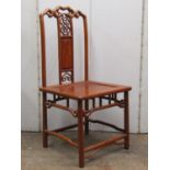 A set of eight Chinese hardwood dining chairs with central splats, pierced rails, solid seats and
