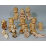 12 all bisque Kewpie type ornamental doll figures, all with side glancing eyes and in various