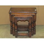 A nest of three good quality reproduction oak occasional tables of rectangular form in the old