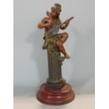 Spelter character group of a fairy type character playing a mandolin seated on top of a Corinthian