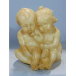 German carved alabaster study of two seated nude children, one with an apple at its feet, with inset