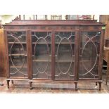 An inlaid Edwardian mahogany breakfront bookcase enclosed by four astragal glazed panelled doors and