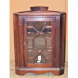 A small Georgian style mahogany corner cabinet enclosed by an astragal glazed panelled door 42 cm