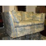 A traditional three piece suite comprising two seat sofa and a pair of matching armchairs with