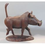 An African hardwood figure of a strutting male warthog. 30cm long