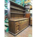 A Georgian oak country made dresser, the base enclosed by a T shaped arrangement of drawers, (3