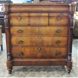A substantial Victorian mahogany bedroom chest fitted with an arrangement of seven drawers with