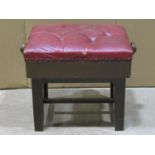 A piano/music stool of rectangular form with buttoned adjustable seat raised on square cut