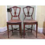 A pair of unusual 19th century mahogany side/hall chairs, the high seats (50 cm) upholstered in hide