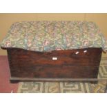 An old stained pine blanket box with later upholstered hinged lid, approx 90 cm long x 50 cm wide