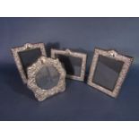 Four silver applied easel frames with blue baize backing, two 19 x 13.5cm, a further landscape