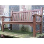 A good quality stained hardwood three seat garden bench with slatted seat and back, labelled