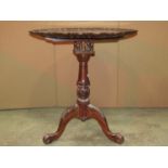 A reproduction Georgian style hardwood tripod table with bird cage action and circular top with