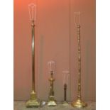 A brass effect standard lamp in the form of a Corinthian column with stepped base and paw feet,