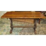 A reproduction oak refectory table, the rectangular top raised on a pair of lyre shaped and sledge