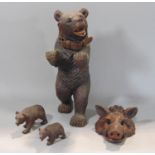 A Black Forest carved study of a standing bear with glass eyes, open mouth, carved teeth and tongue,