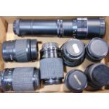 A group of prime and zoom lenses with mixed camera mounts.