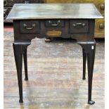 Georgian oak country made lowboy fitted with three frieze drawers within a shaped frieze raised on