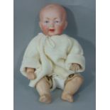 Early bisque socket head character baby boy doll by Kestner, with kid body and kid upper legs,