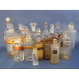 Large collection of various sized clear glass apothecary bottles, many with original stoppers and