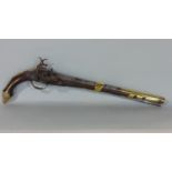 19th century miquelet lock, a pistol with carved hardwood frame, heavily overlaid in brass, 50cm