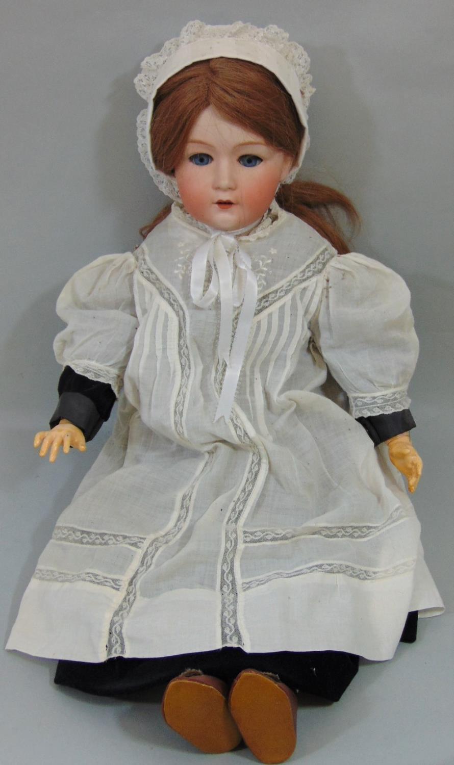 Early 20th century Gebruder Heubach bisque head doll with jointed composition body, fixed blue eyes,