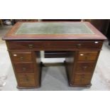 A small Victorian mahogany kneehole twin pedestal desk with inset green leather panelled top over an
