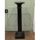 A 19th century ebonised column of circular fluted form, square cut base and top, 110 cm in height