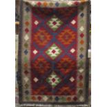 A flat weave Kelim rug with multi geometric detail, within running borders, 160 x 105cm