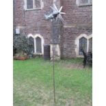 A novel contemporary light metal garden ornament in the form of a vintage bi-plane with wind
