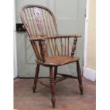 A Georgian ashwood Windsor elbow chair with shaped and pierced splat, dished seat on turned supports