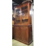 A Victorian mahogany library bookcase in two sections, the lower enclosed by a pair of fielded