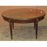 An Edwardian mahogany occasional table of rectangular form with canted corners and turned supports