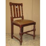 A set of six 1920s walnut slat back dining chairs with drop in upholstered seats raised on barley