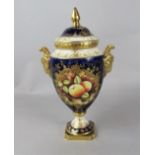 A Coalport two handled vase and cover with painted fruit decoration by Linda Owen on a dark blue and