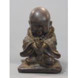 Unusual cast bronze study of a praying Buddhist child holding a Chinese radish, 18 cm high