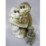 A continental group of a pair of embracing monkeys, both with glass eyes and impressed marks to
