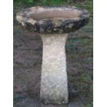 A rough hewn natural stone two sectional bird bath of oval form 58 cm high