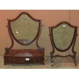 Two Georgian style toilet mirrors of shield shaped form, one with skeleton frame, the other with bow