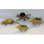Four cast metal pen brushes in the form of animals to include two warthogs, a monkey and an otter,